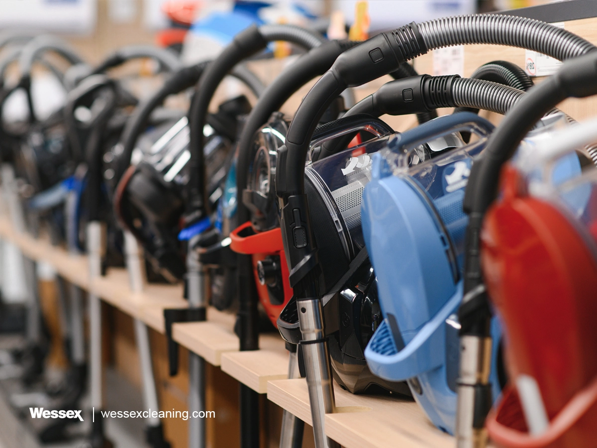 A variety of vacuum cleaners lined up, showcasing different models