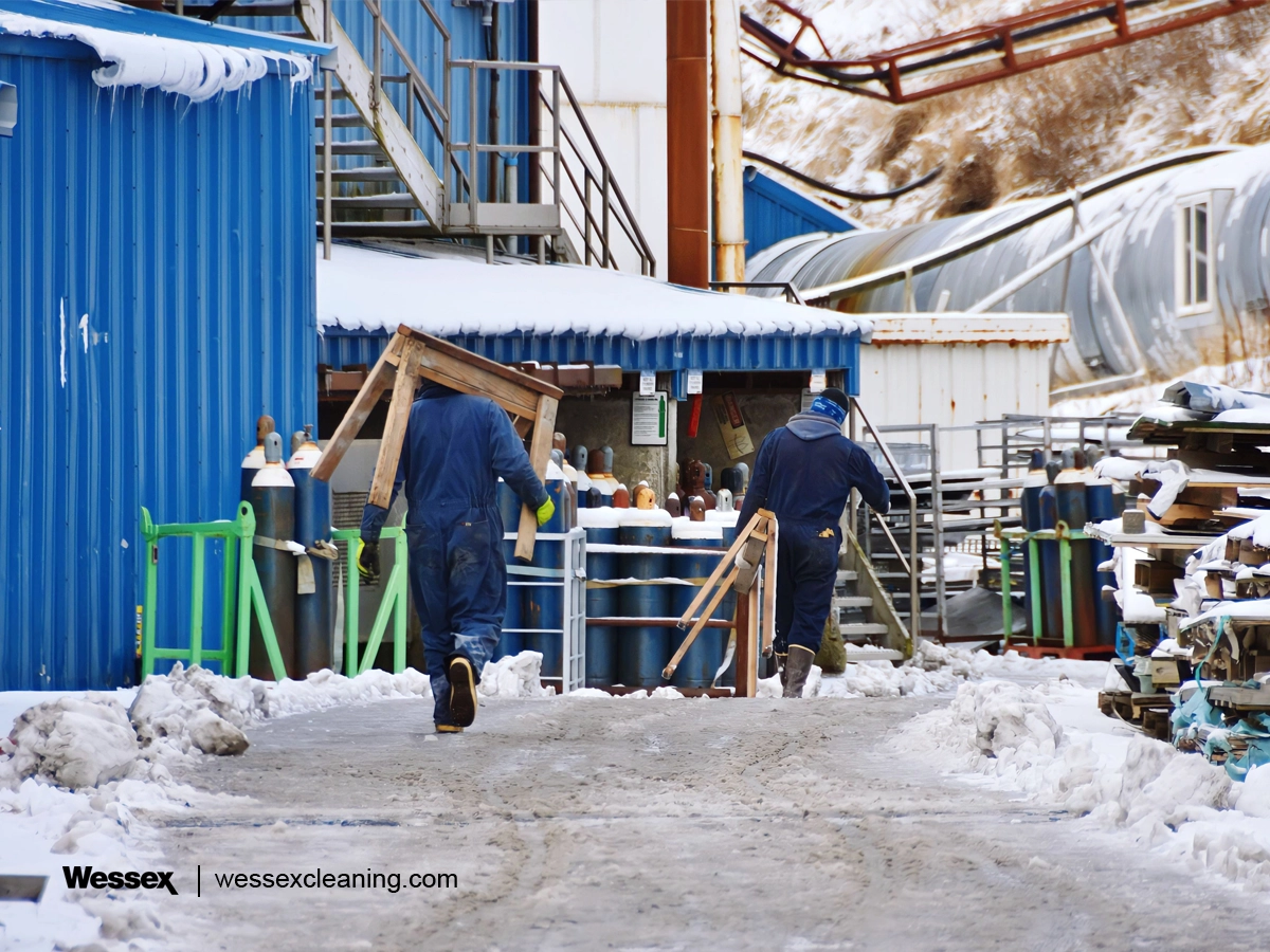 Construction workers performing a deep clean at a business during winter, preparing for the year-end.