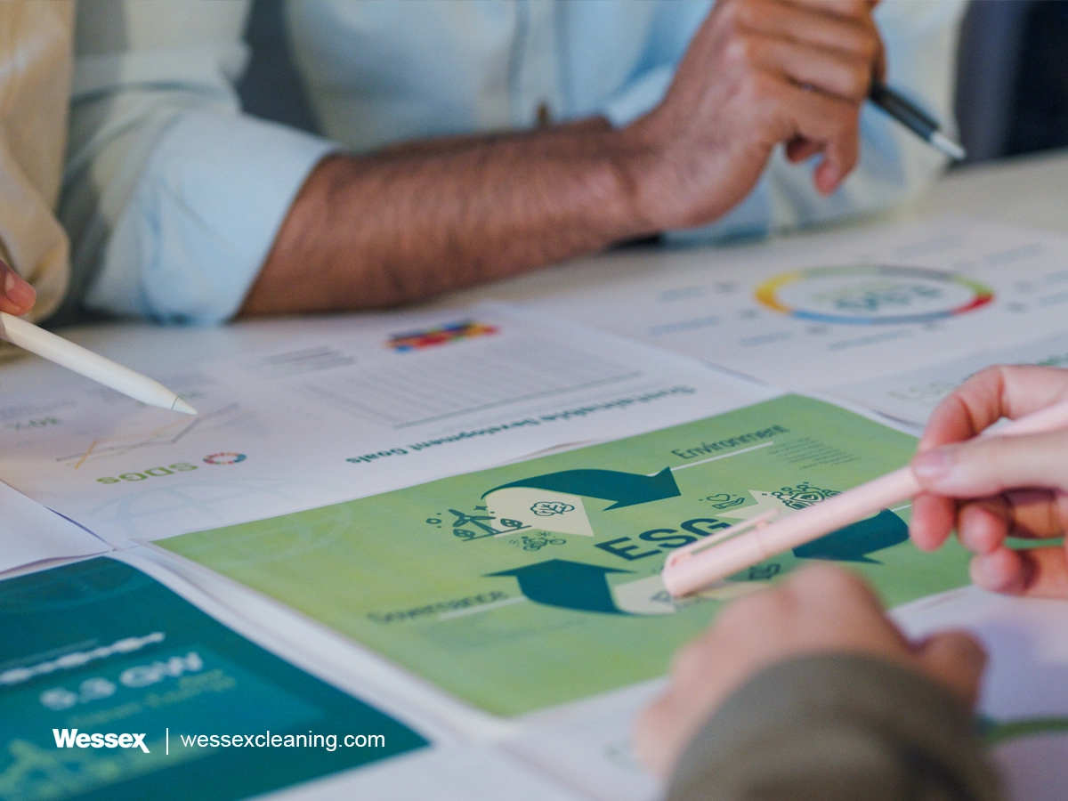 Close-up of a group of businesspeople discussing ESG strategies to improve carbon footprint reporting and sustainability efforts.