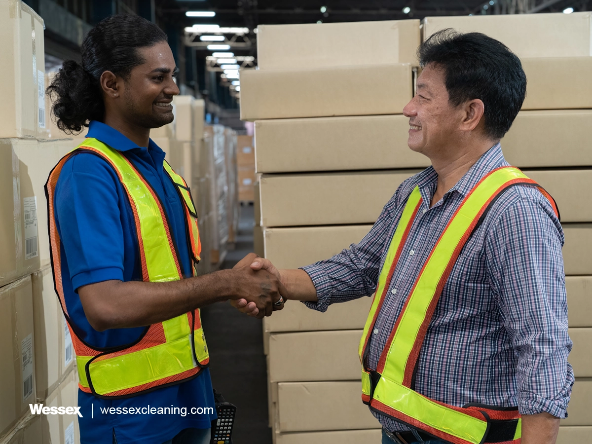 Supplier and warehouse manager shaking hands, ensuring SDS compliance
