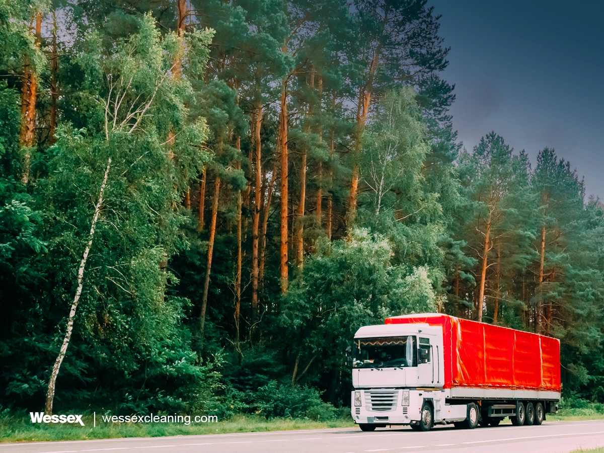 Supplier truck driving through a forest, representing the sustainable carbon footprint journey from cradle to grave and beyond.