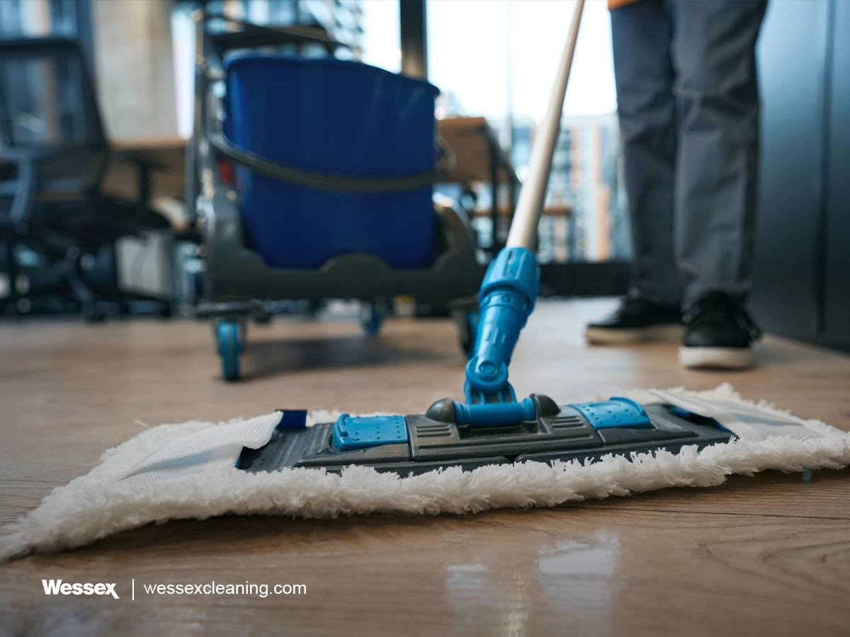 Cleaning specialists manually cleaning a coworking office space