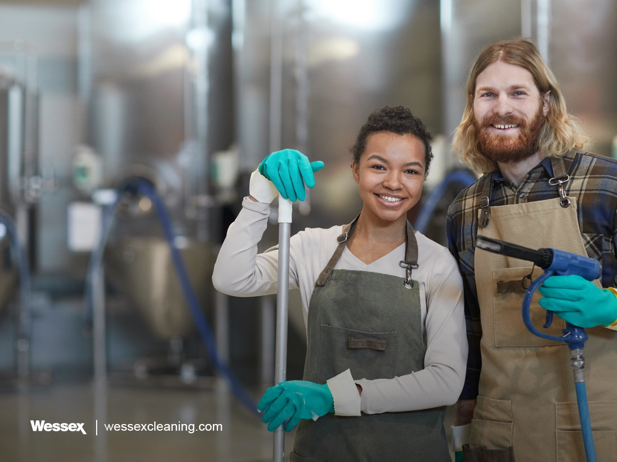 Two cleaning workers smiling at the camera, representing cleaning business teams