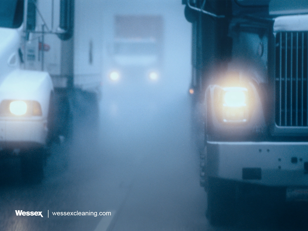 Partial view of a large commercial truck emitting smoke, illustrating TTW and WTT emissions